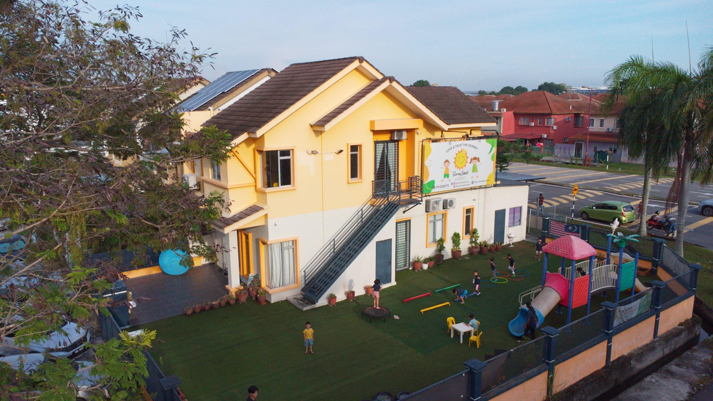 Aerial photograph of the SunnySeeds school house and garden playground, Aman Perdana
